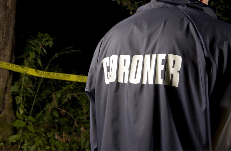 Man wearing Coroner's jacket at crime scene